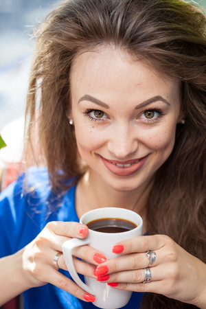 Beautiful smiling woman drinking a cup of coffee. Coffee drinker.の写真素材
