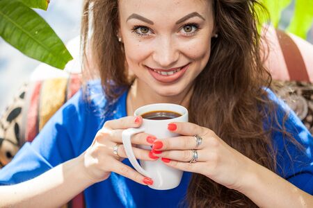 Beautiful woman drinking a cup of coffee. Coffee drinker.の写真素材