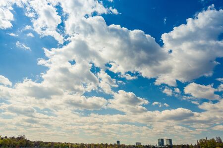 Clouds over park from the city and office buildings in the background. Beautiful blue skyの写真素材