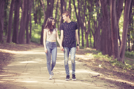 Inlove couple taking a walk in the forest. Lifestyle and relationship. Young inlove boyfriend and girlfriendの写真素材