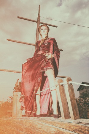 Glamour Woman in vintage clothes on a boat. Retro style. Elegance and glamourの写真素材