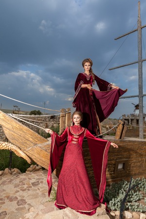 Two ladies in vintage clothes on a boat. Luxury and glamourの写真素材
