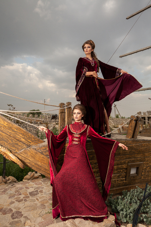 Two beautiful ladies in vintage clothes on a boat. Luxury and glamourの写真素材