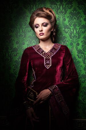 Portrait of beautiful woman with perfect make up on vintage background in retro and interior. Rococo period. Luxury and high classの写真素材