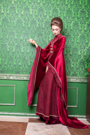 Gorgeous woman dressed in vintage clothes in retro interior. Rococo period. Luxury and high classの写真素材