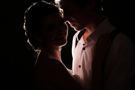 Inlove bride and groom together backlit in vintage interior. Happiness and marriageの写真素材