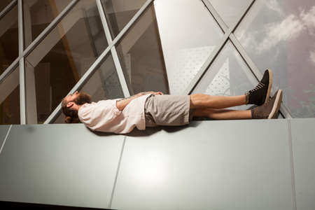 Cool bearded tattooed hipster posing in front of office building. Modern start up companyの写真素材