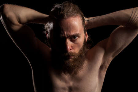 Hipster with long beard on black background in studio photo. Expression and fashionの写真素材