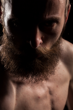 Angry hipster in dramatic photo on black background in studio. Expression and fashionの写真素材