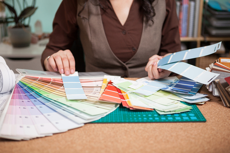 Architect choosing from different colors on the cards in front of her. Architecture and construction. Color palleteの写真素材