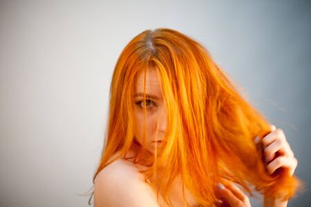 Dreammy portrait of bright redhead woman in soft focus in studio photo. Attractive and beautiful womanの写真素材