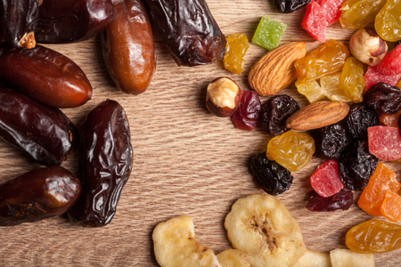 Mix of dried fruits on wooden background in studio photo. Healthy lifestyleの写真素材