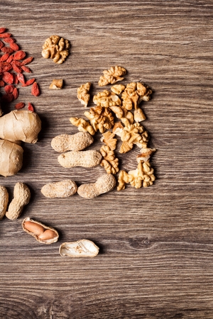 Mix of different type of nuts on wooden background in studio photoの写真素材