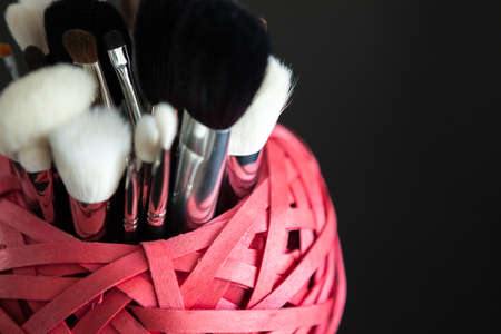 Make up and cosmetics products on black background. Professional Cosmeticsの写真素材