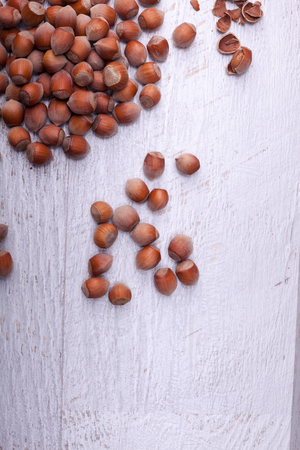 Hazelnuts on wooden background. Over top viewの写真素材