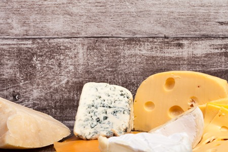 Different type of cheese on wooden background. Gourmet food apetizerの写真素材