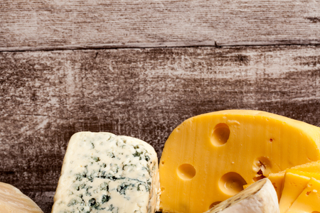 Different type of cheese on wooden background. Gourmet food apetizerの写真素材