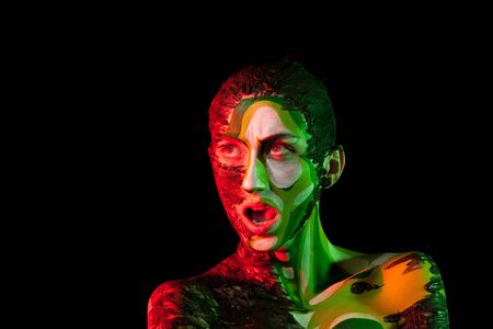 Extreme fashion make up in red and green studio light. Beauty and fashion. On stage make up