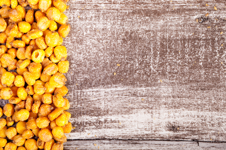 Roasted corn on wooden background with copyspace available. Close up photo. Delicious salty roasted...