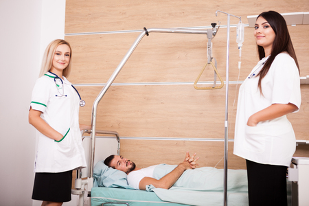Patient in hospital room next to nurses. Medical and healthcareの写真素材