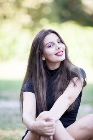 Portrait of Pretty young woman posing in the park. Outdoor portrait. Fun and relaxation