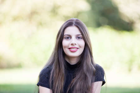 Portrait of Pretty young woman posing in the park. Outdoor portrait. Fun and relaxation