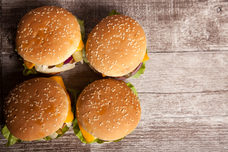 Delicious tasty hamburgers on wooden background. Fast and tasty foodの写真素材
