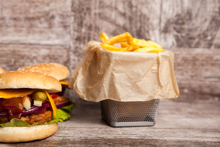 Delicious tasty cheeseburgers on wooden background. Fast and tasty foodの写真素材