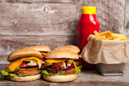 Delicious tasty meal burgers on wooden background. Fast and tasty foodの写真素材