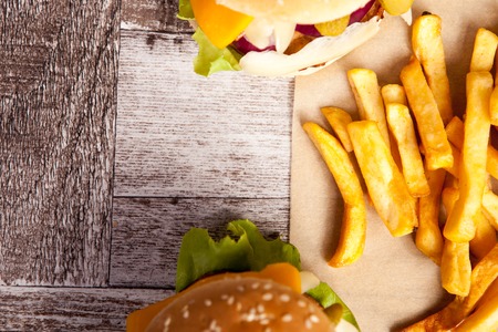 Snack of Delicious tasty burgers on wooden background. Fast and tasty foodの写真素材