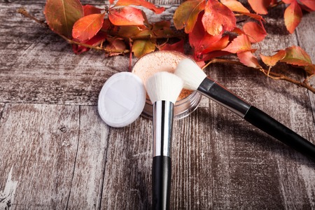 Professional cosmetics make up prducts in autumn concept on dark wooden background. Studio photoの写真素材