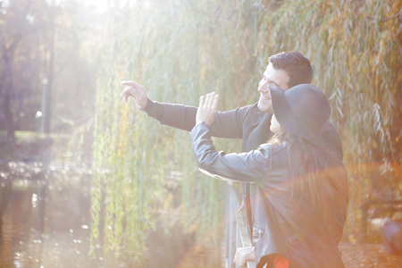 Gourgeous couple walking in autumn park near a lakeの写真素材