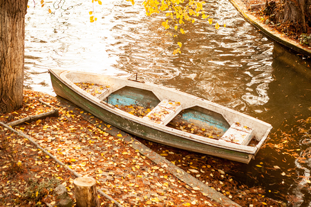 Boat in a lake in autumn park. Scenery and tranquilの写真素材