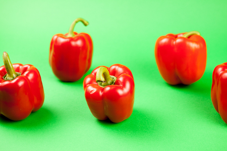 Group of fresh healthy sweet red pepper on green backgroundの写真素材