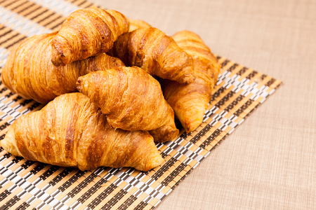 Delicious fresh baked croissants on a tableの写真素材