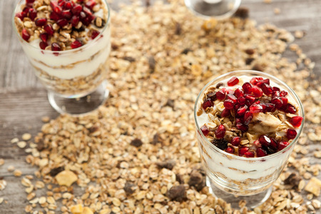 Close up on healthy and delicious muesli with pomegranate on topの写真素材