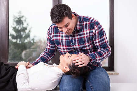 Inlove beautiful woman in men laps lookign up at him. Love and happinessの写真素材