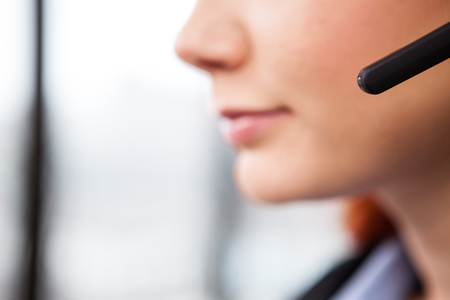 Close up of unrecognisable woman wearing a speaking handsfree headsetの写真素材