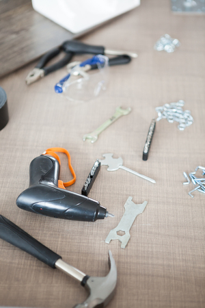 Electric screwdriver and other tools on a desk