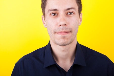 Close up portrait of confident man over yellow backgroundの写真素材
