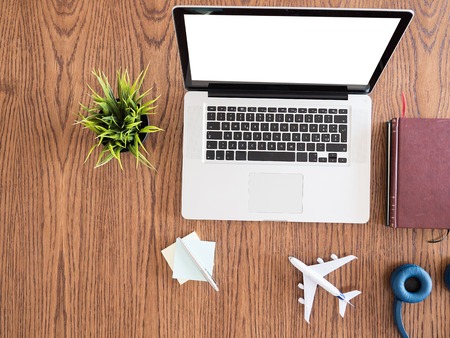 Top view  of businessman wooden desk concept image, pot of grass,books , notes, headphonesの写真素材