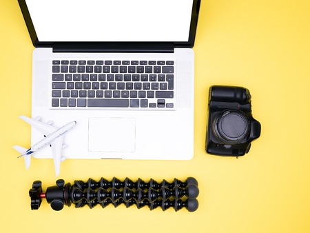flat lay on yellow backround of photographer,camera, laptopの写真素材