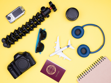 Travel accessories of a hipster photographer on yellow backgroundの写真素材