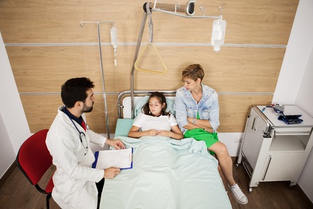 Doctor visitin her patient in hospital roomの写真素材