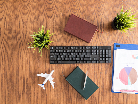 Traveler businessman desktop concept image, books , pen , clipboard, pot of grassの写真素材