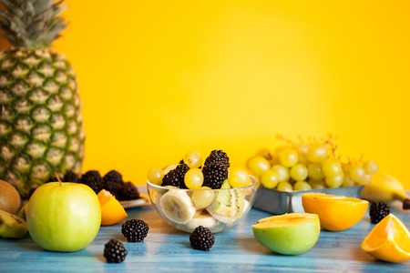 Ready for summer fruit variety on blue wooden desk. Mixed summer oraganic fruits assortmentの写真素材