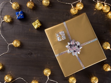 Top view of golden christmas gift boxes on old vintage wooden background. Winter celebrationの写真素材