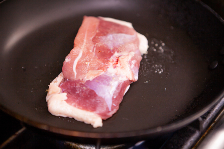 Chef fries duck breast on pan in restaurant kitchenの写真素材