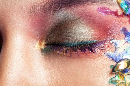 Portrait of a beautiful Girl with colorful makeup on her face. Creative makeup. Fashiom model.