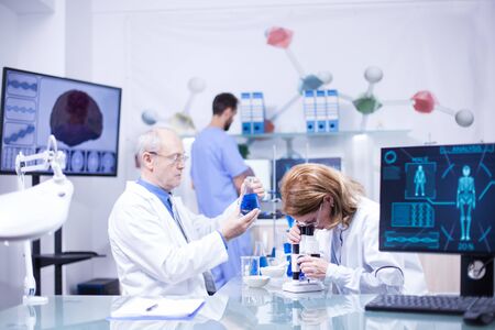 Groupe of researchers in pharmacology in a hospital laboratory. Modern equipment in research laboratory.の写真素材